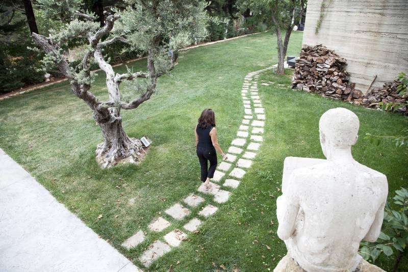 Raghad Mardini, founder of the Art Residence Aley, walks through the grounds of the retreat. She renovated an old coach house to create studio space for Syrian artists.