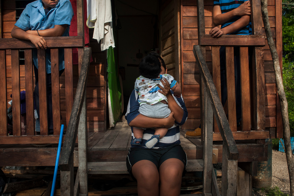 Belize. Daily life of family who fled from gangs violence of El Salvador.