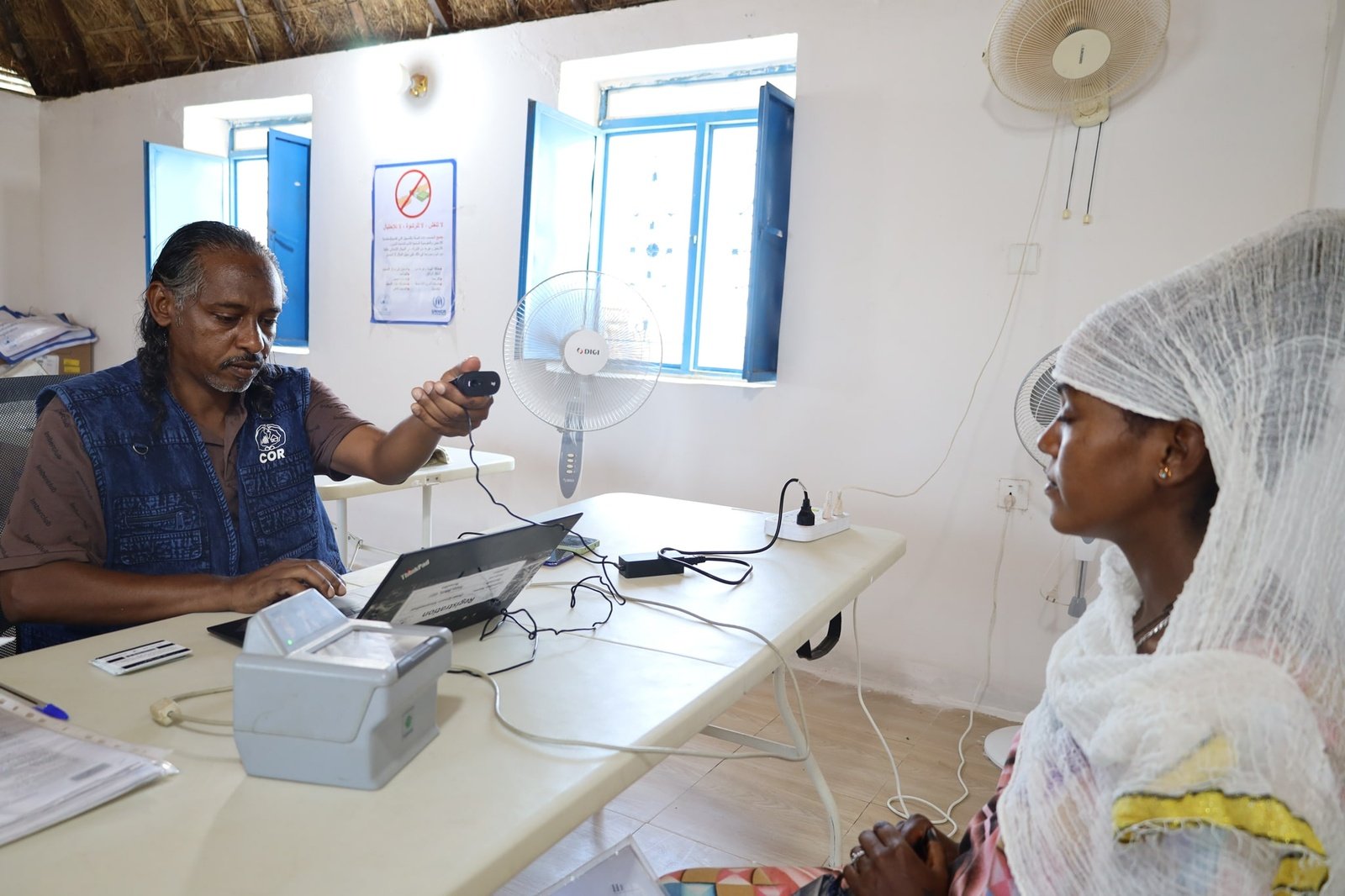 Refugees and asylum-seekers undergo registration at the UNHCR registration desk in Um Gargour camp, Gedaref State. Since April 2023, over 8,700 individuals in Gedaref have been registered or had their information updated by UNHCR and COR, ensuring better access to essential humanitarian assistance and services.