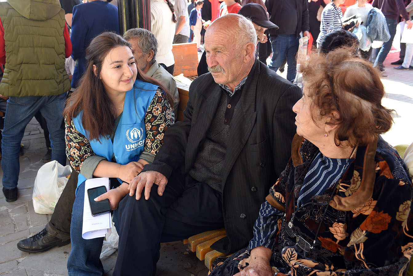 UNHCR employee with refugees in Goris, Armenia. September 2023