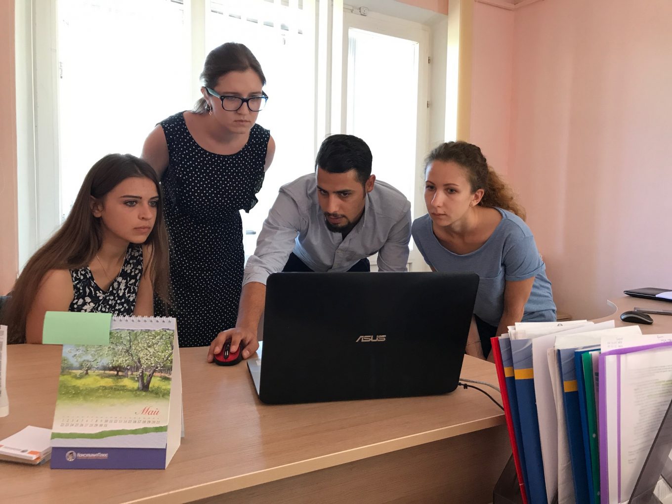 © UNHCR/ Charlotte Arnaud / A few days after the training, Mohammad Anini from the deployment team visited Volha Bakhur Julia Dvydova and Hanna Bystrova in the offices of the Refugee Counseling Service, to answer questions and support the new users. 