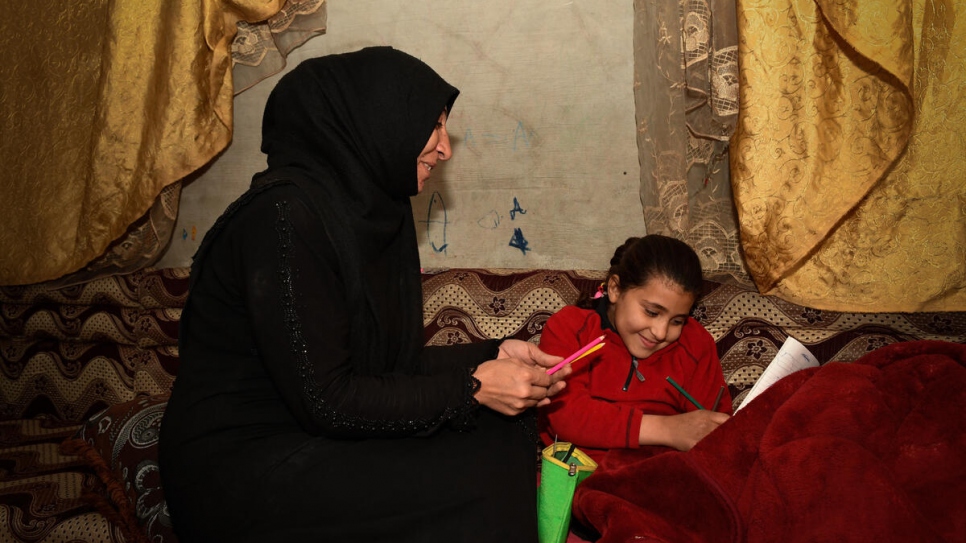 Samar 37 sits with her daughter who lost a leg in an explosion aged 18-months_UNHCR_Bassam Diab