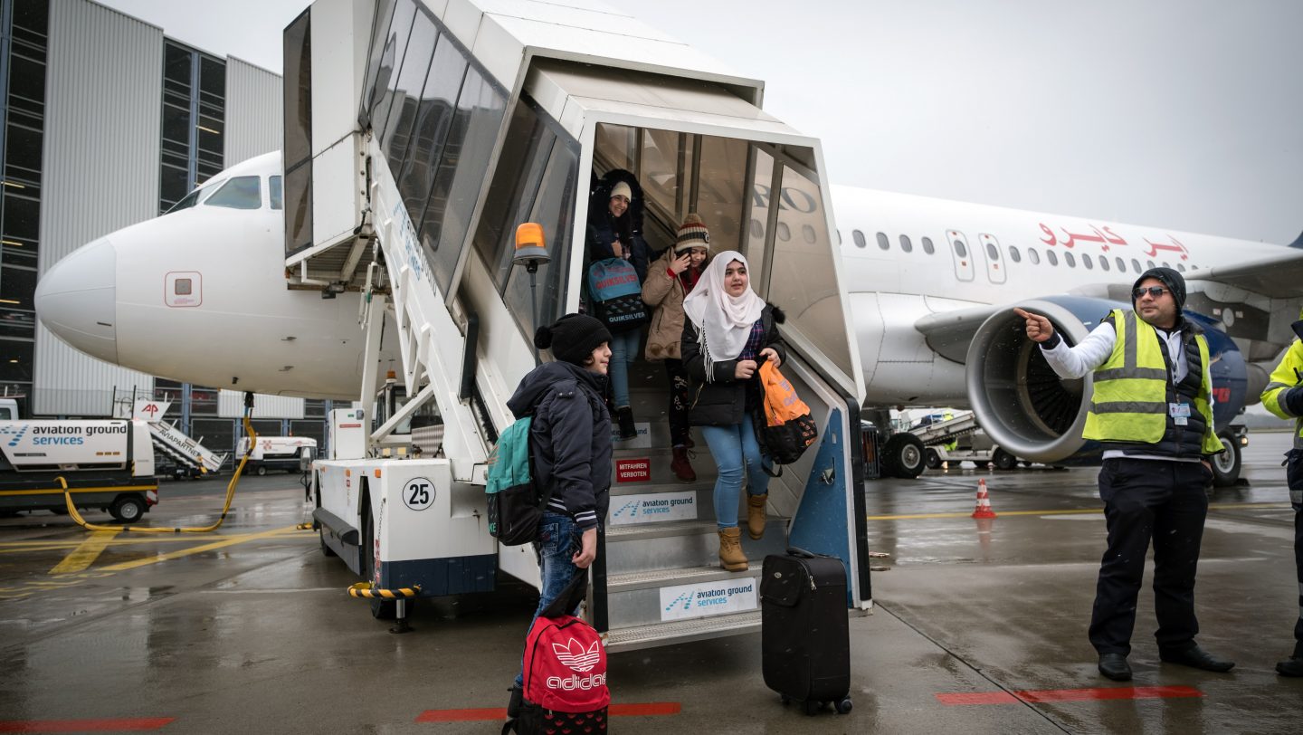 Germany. Syrian and non-Syrian resettlement refugees arrive via air charter at Hanover Airport.