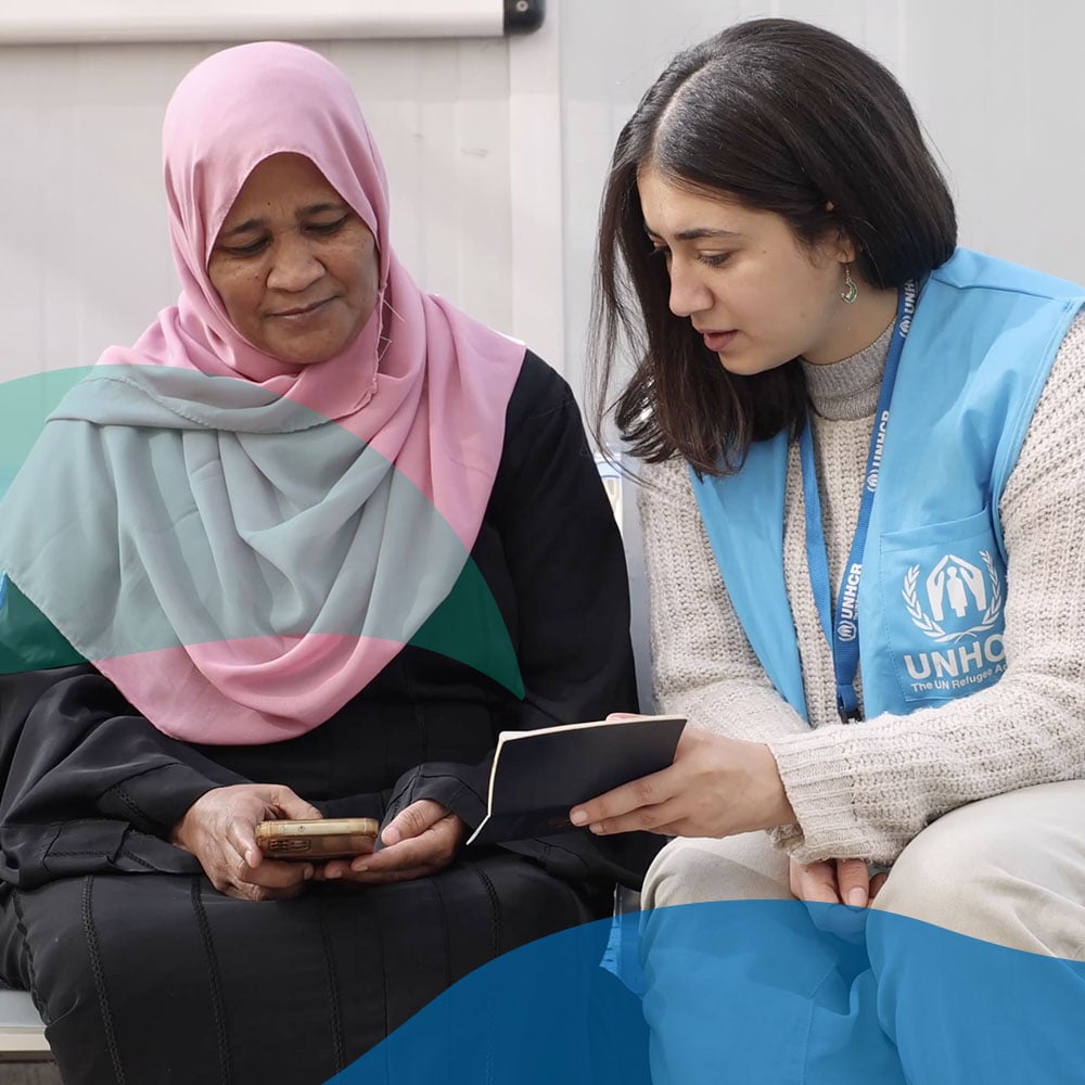 One of the UNHCR staff testing the new onboarding tool with a Sudanese refugee. This tool will enable new arrivals from Sudan to request a registration appointment with UNHCR on any digital device. UNHCR/Pedro Costa Gomes.