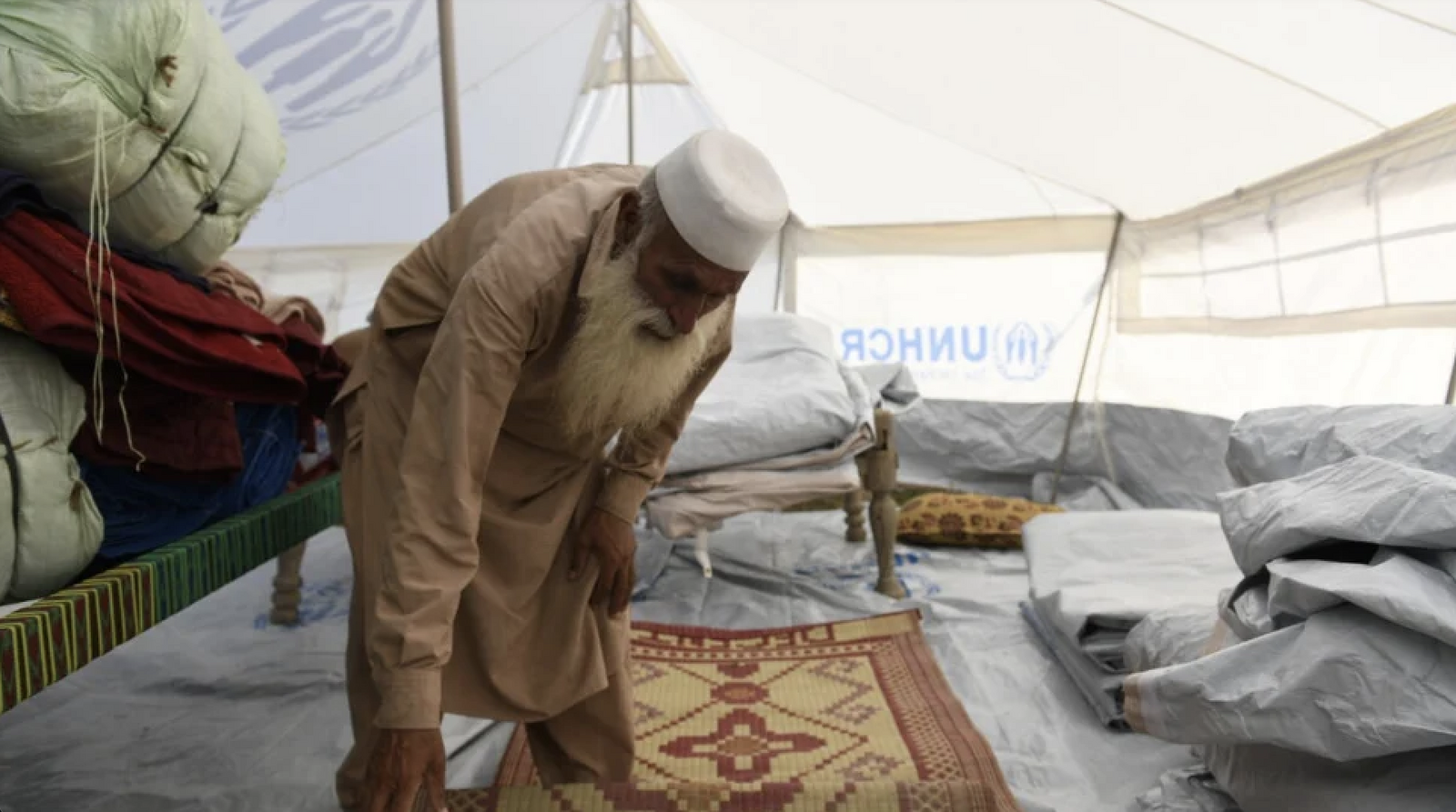 Bahadur and his family are now sheltering in a tent provided by UNHCR on higher ground near his village. © UNHCR/Usman Ghani