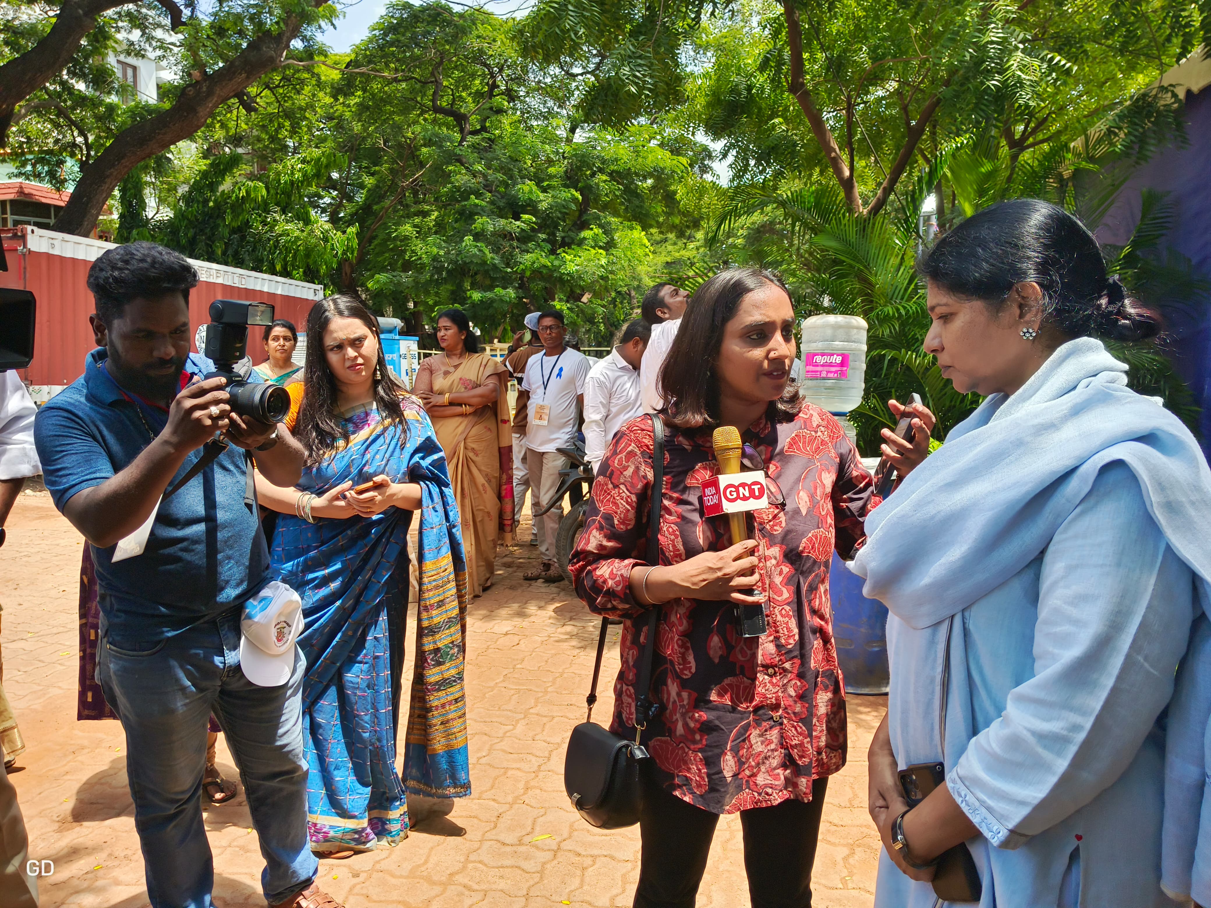 Refugee photographer Gowri at a WRD event taking photos of a Member of Parliament who attended the event.