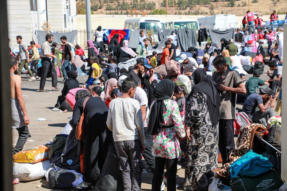 Huge groups of people gather outside at the Masnaa border crossing between Syria and Lebanon