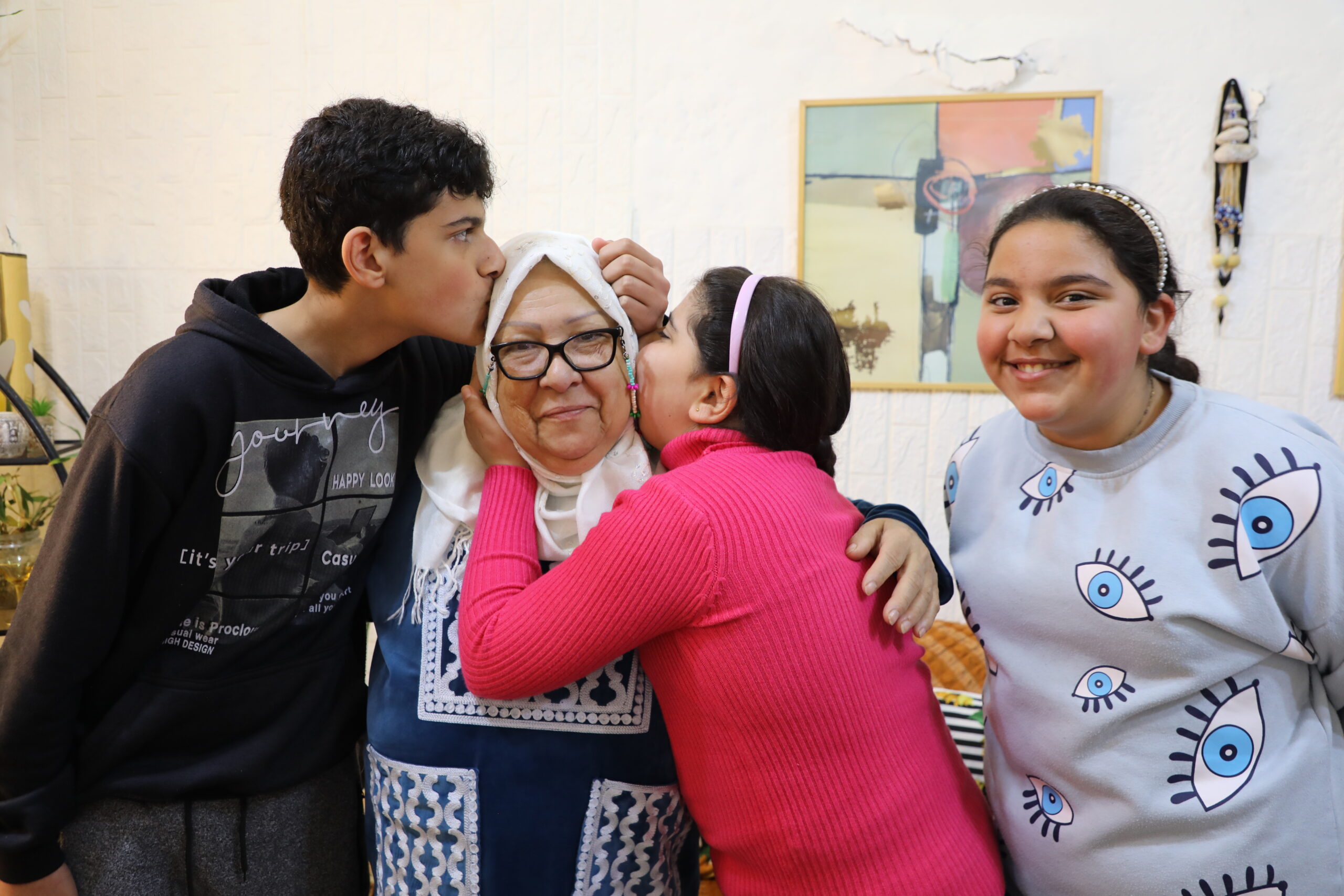 A warm embrace full of love as Ali, Baneen and Rimas cherish the heart of their family. © UNHCR/Batool Ghaith