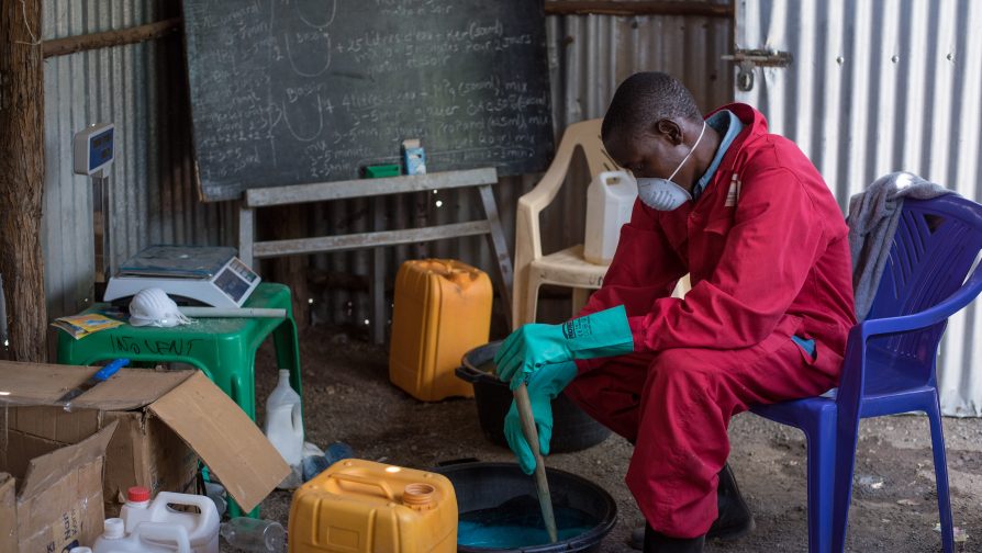 Innocent prepares liquid soap at his homestead in Kakuma Refugee Camp, where he has set up a laboratory for soap production. ©UNHCR/Samuel Otieno