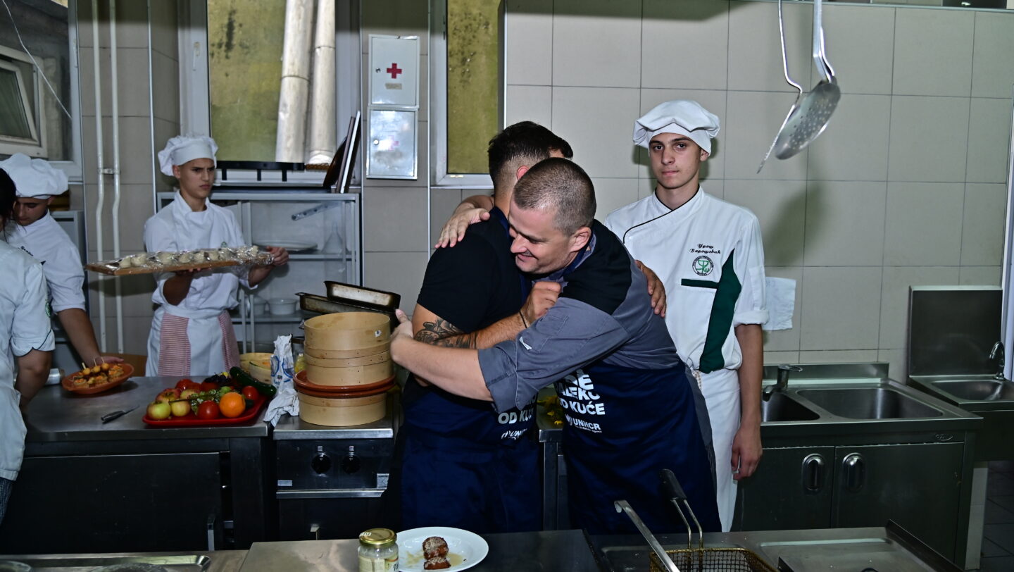Chefs Karox and Nikola exchanging a “well done” hug, having tasted the fresh falafel they made together, ©UNHCR/Kharim Nsengiyumva, Belgrade, 20 June 2024