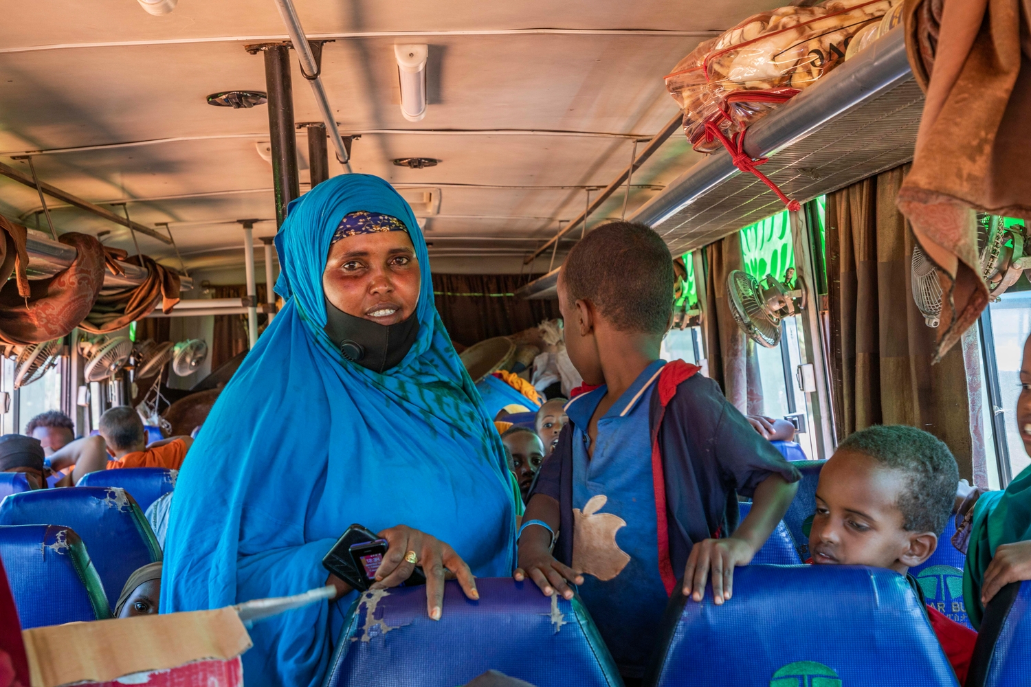 Hinda Mahdi and her family aboard the bus to the new Mirqaan settlement.