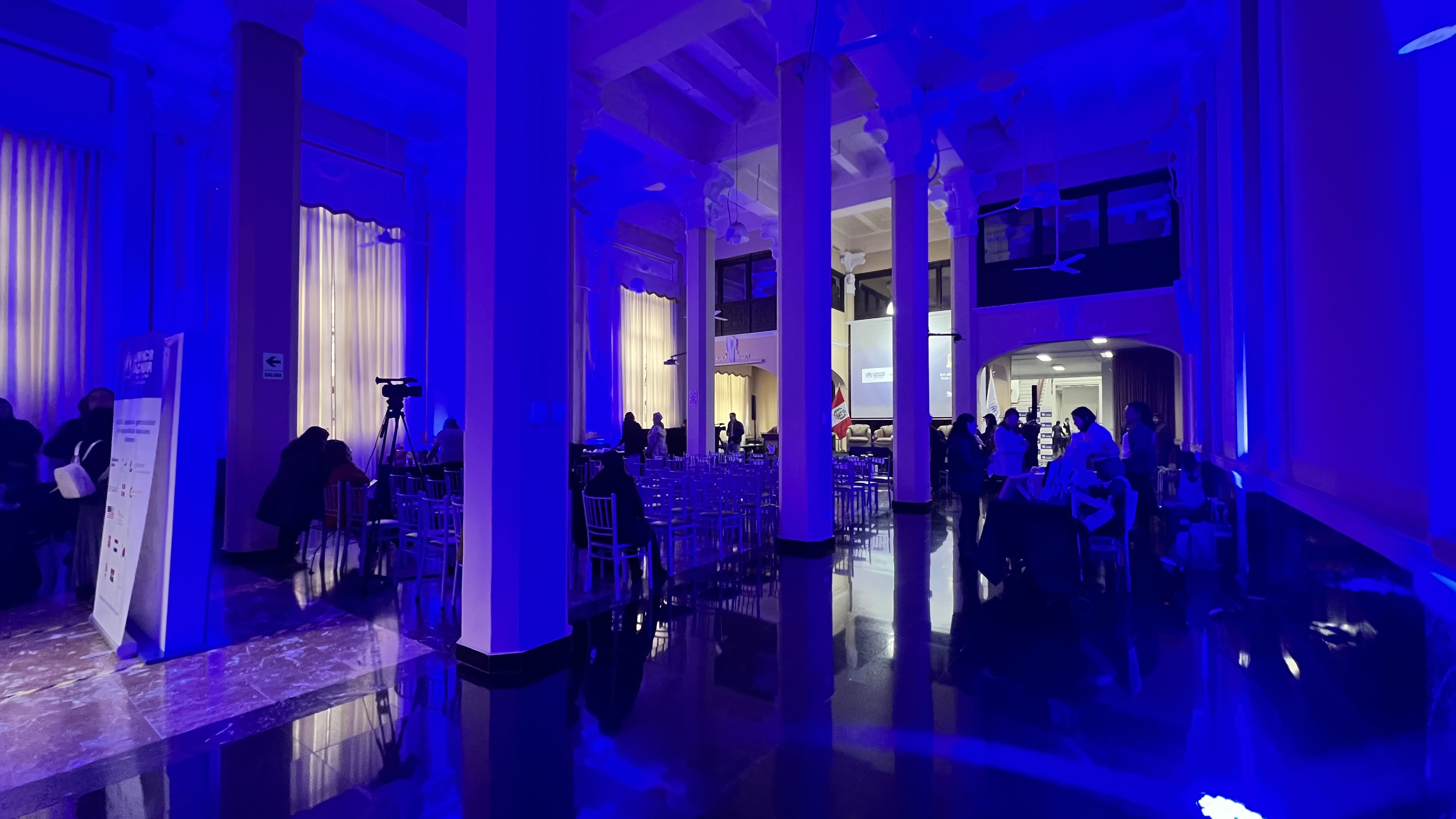 The interior of a large room illuminated in blue light.