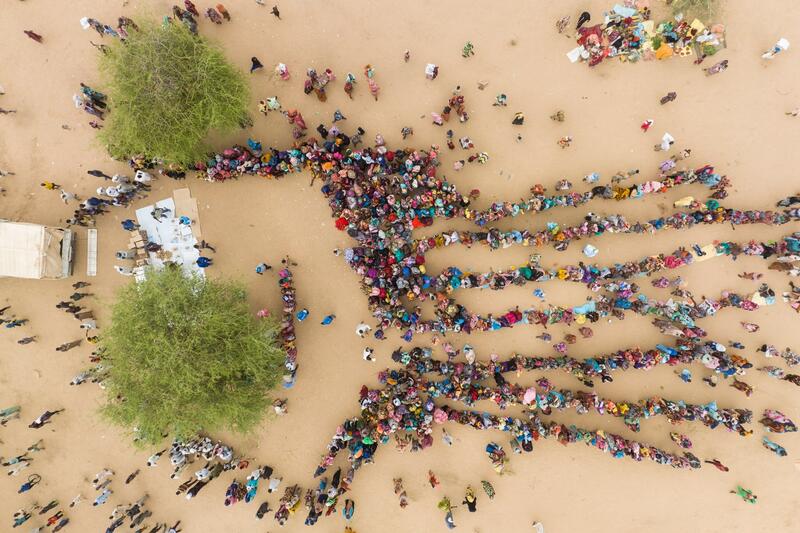 An aerial view of people lining up to receive aid in Chad.