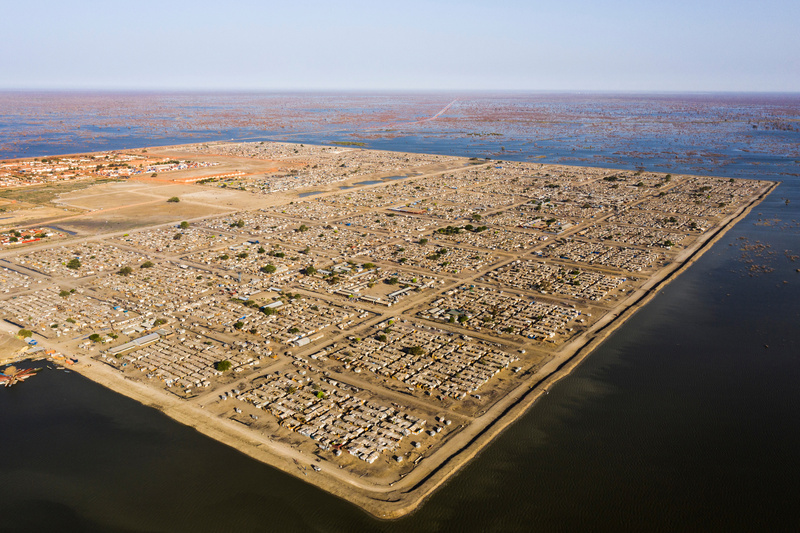 A settlement surrounded by flood waters so it resembles an island.