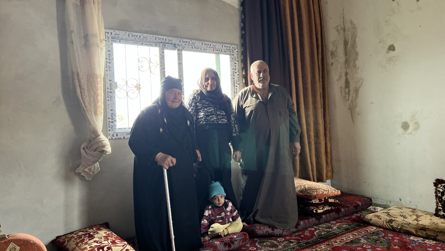 Badriyah, together with son Wael and daughter- in- law are sitting in a room which was previously a warehouse. © UNHCR/Vivian Tou'meh