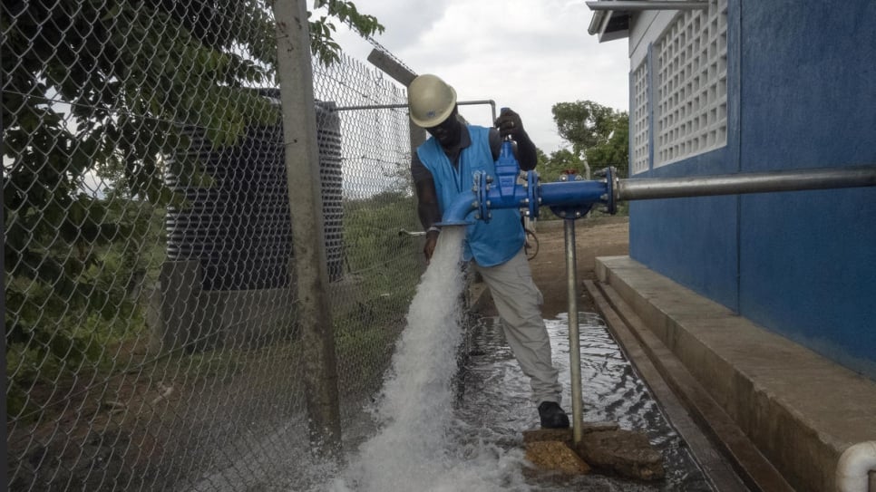 Water, sanitation and hygiene officer Richard Ochaya opens the water supply at the Obomiri project to distribute water to Bidi Bidi refugee camp using solar pumps and boreholes.