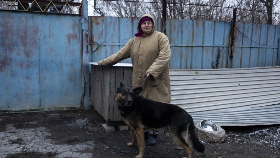 Stefania and her dog outside the neighbour’s house where she is living in Mykolayivka, Donetsk. ©UNHCR/Anastasia Vlasova
